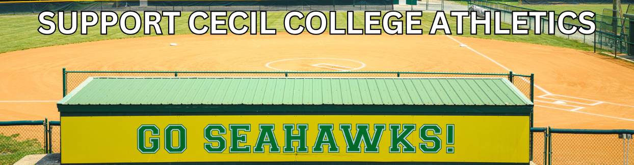 A photo of the cecil college softball field with green and yellow lettering. The words support the seahawks are featured in the middle.